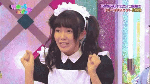 a girl in a maid costume is making a funny face with her hands in the air