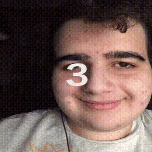 a close up of a man 's face with the number 3 on his nose