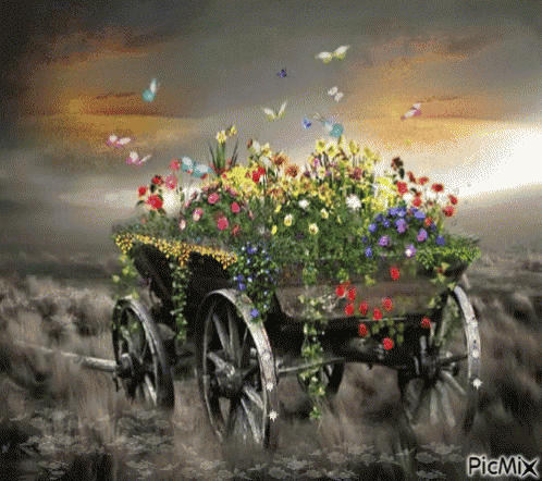 a picture of a wagon filled with flowers and butterflies with the watermark picmix