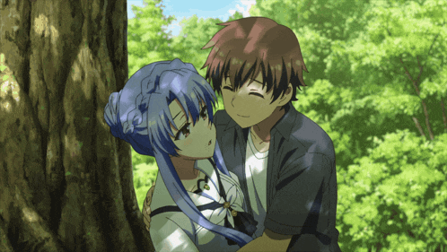 a boy and a girl are hugging under a tree in a forest