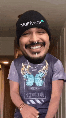 a man wearing a beanie and a t-shirt with a butterfly on it