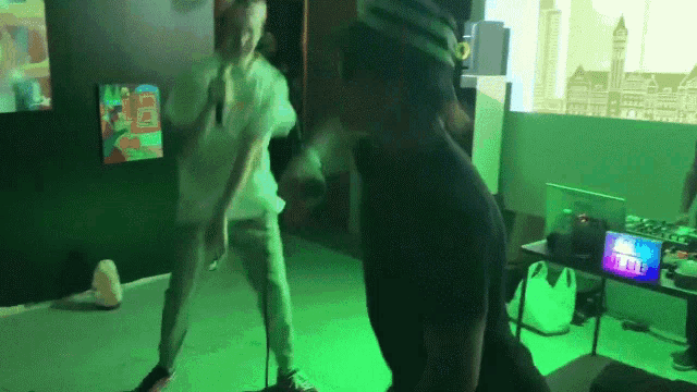 a man wearing a virtual reality headset is dancing in a room