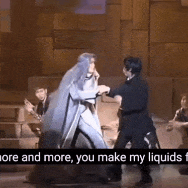 a couple of people are dancing on a stage with the words `` more and more , you make my liquids '' written on the bottom