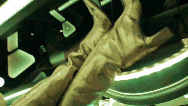 a person 's feet are shown in a blurry photo with a green background