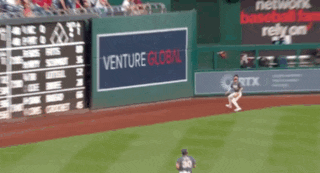 a baseball field with a venture global sign