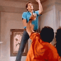 a man in a blue shirt is dancing in front of a group of children