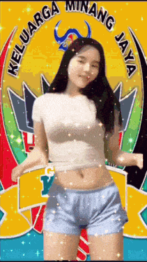 a woman in a white shirt and blue shorts is dancing in front of a logo for keluarga minang jaya