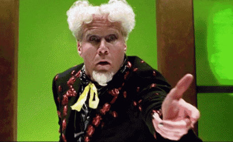 a man with white hair and a beard is pointing his finger at something .