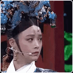 a woman is wearing a headpiece and a microphone .