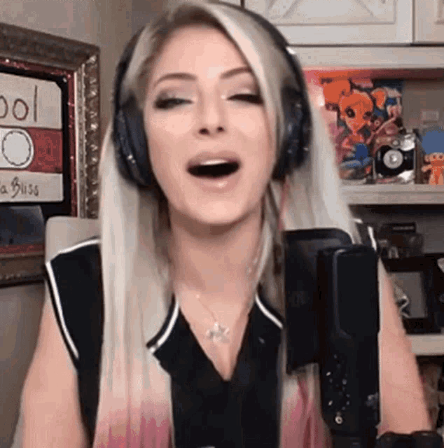 a woman wearing headphones is talking into a microphone .