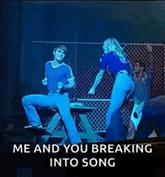 a man and a woman are dancing on a stage with the words `` me and you breaking into song '' written on the bottom .