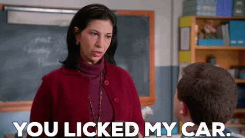 a woman is talking to a boy in a classroom and says " you licked my car " .