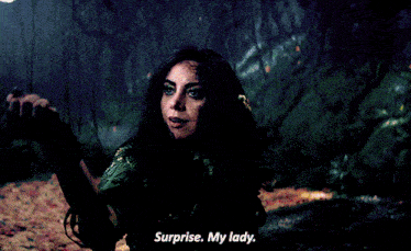 a woman is holding a flower in her hand and saying surprise my lady