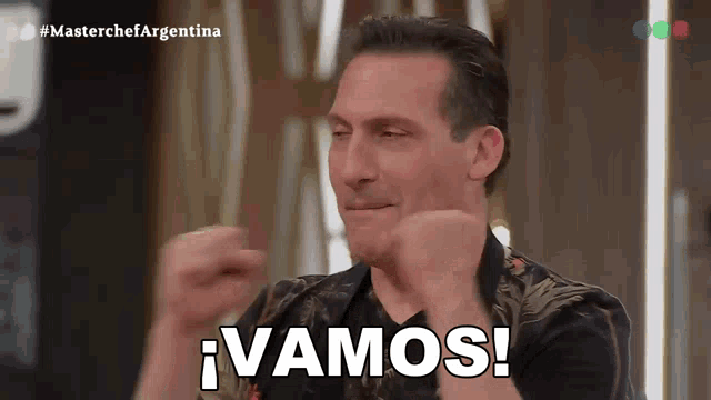 a man is making a funny face and says vamos on the screen