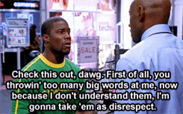 a man in a green and yellow shirt talks to another man in front of a sale sign