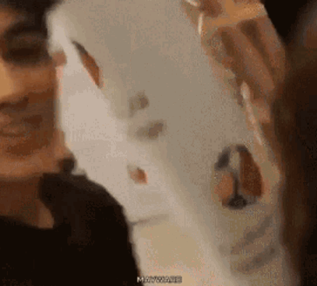 a close up of a person holding a piece of paper with the word mayonnaise written on it