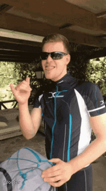 a man wearing sunglasses and a shirt with x on it