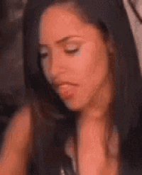 a close up of a woman 's face with her eyes closed .