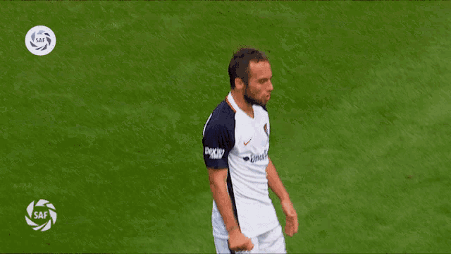 a man in a banco civil jersey is dancing on a field