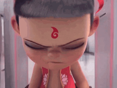 a cartoon character with a red symbol on his forehead is making a funny face .