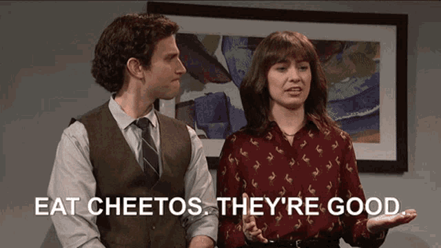 a man and a woman are standing next to each other with the words eat cheetos they 're good