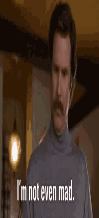 a man with a mustache and a turtleneck sweater is saying that 's amazing .