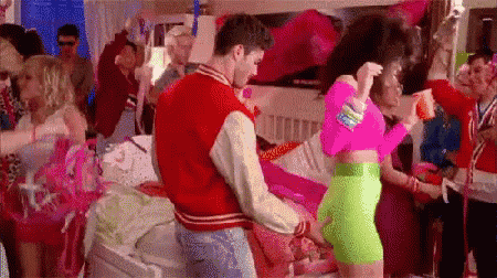 a man and a woman are dancing at a party .