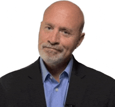 a bald man with a beard wearing a suit and blue shirt .