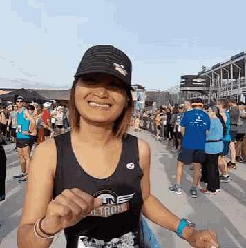 a woman wearing a black tank top that says detroit