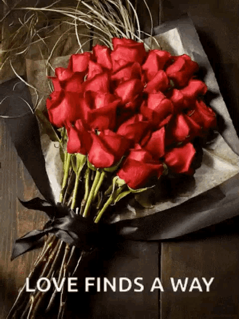 a bouquet of red roses with the words love finds a way below