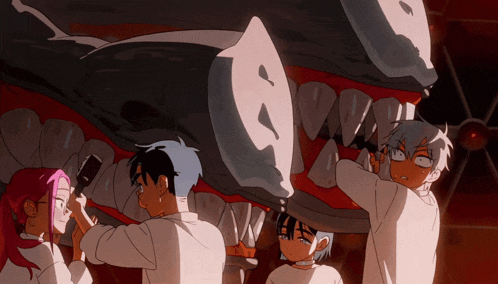 a group of people are standing around a shark 's mouth looking at it