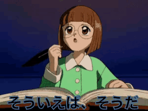 a girl in a green shirt is holding a pen and looking at a book