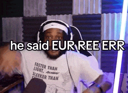 a man wearing headphones and a shirt that says `` he said eur ree err '' is playing a video game .