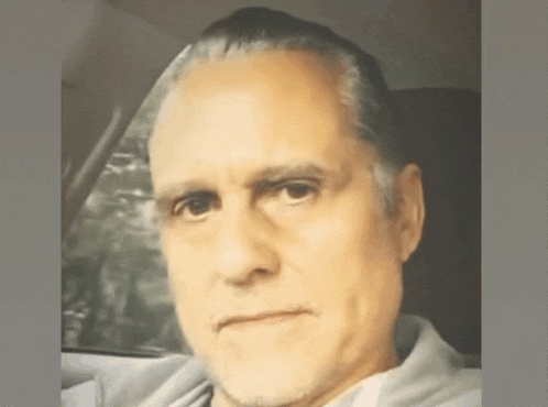 a man sitting in a car looking at the camera