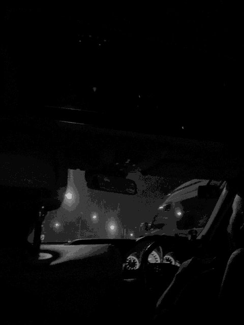 a black and white photo of the inside of a car
