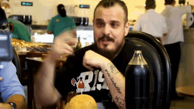 a man with a tattoo on his wrist that says ' r.i. '