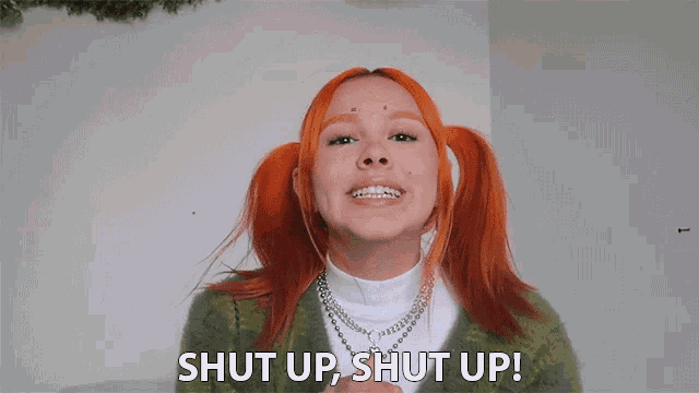 a woman with red hair and pigtails says " shut up shut up "