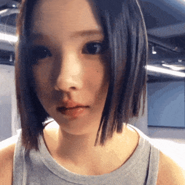 a close up of a woman 's face with short hair