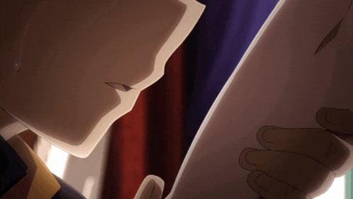 a close up of a person holding a piece of paper in their hand