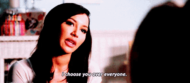 a woman is talking to another woman in a room and says `` i choose you over everyone . ''