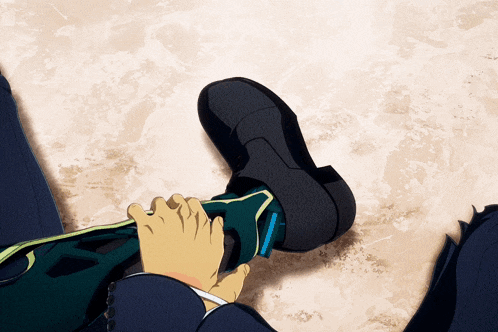 a man in a suit is putting on a pair of shoes