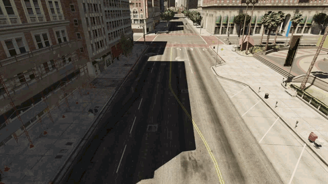 an aerial view of an empty city street with a shadow on the road