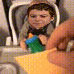 a baby is sitting in a high chair with a toy in his hand