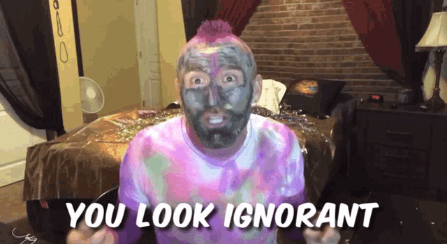 a man with a purple mohawk and a black face paint says " you look ignorant "