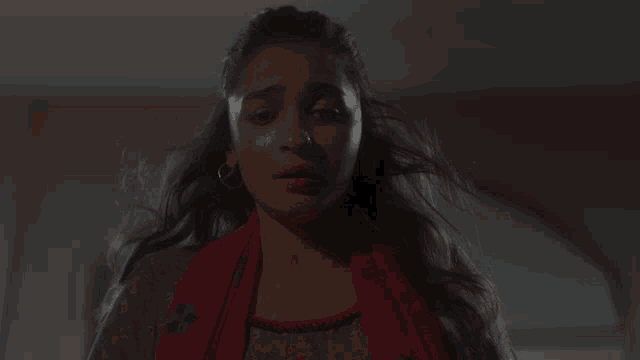 a close up of a woman 's face with a tear running down her cheek