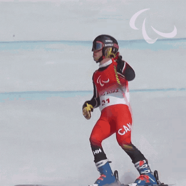 a skier wearing a red and white uniform with the number 21 on it