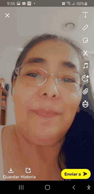 a woman wearing glasses is smiling in a snapchat screenshot