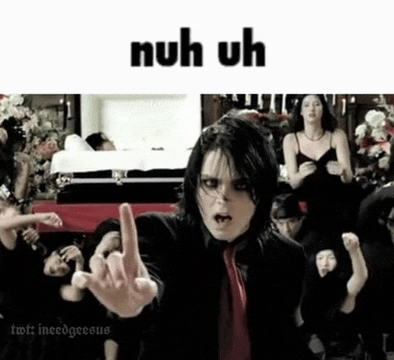 a man in a suit and tie is giving the middle finger in front of a group of people .