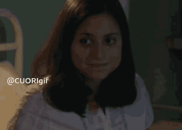 a woman in a pink shirt is smiling with the hashtag @cuorigif