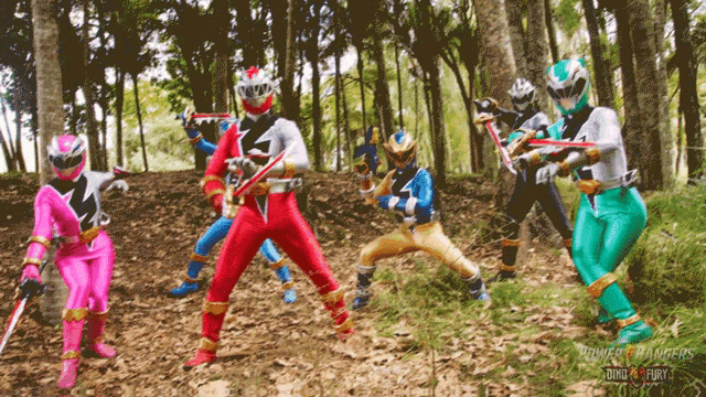 a group of power rangers in the woods